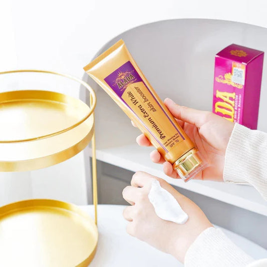 Hand holding a tube of cream with a purple box in the background