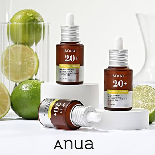 Anua vitamin C serum bottles with limes on a white background