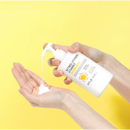 Hand holding a bottle of skincare product with a yellow background