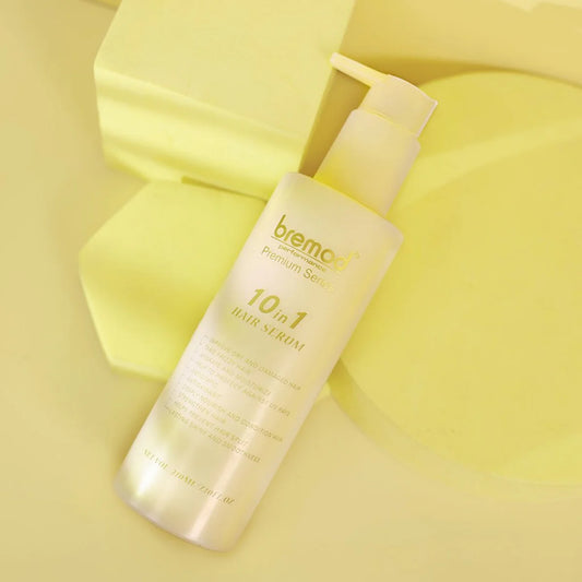 Bremor 10-in-1 hair serum bottle on a yellow background