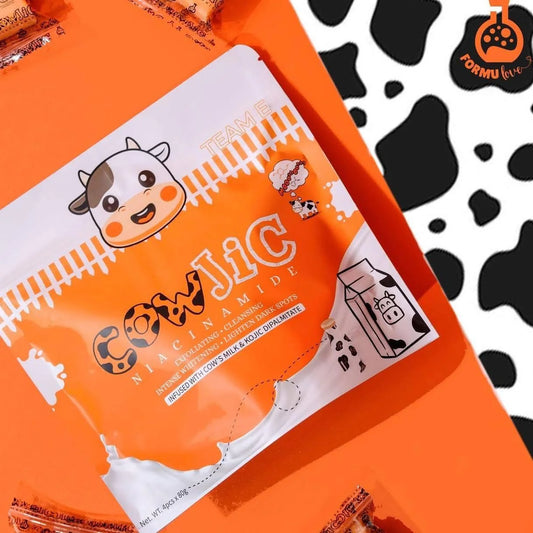 Orange and white packaging of Cow Jic with a cow illustration on an orange background.