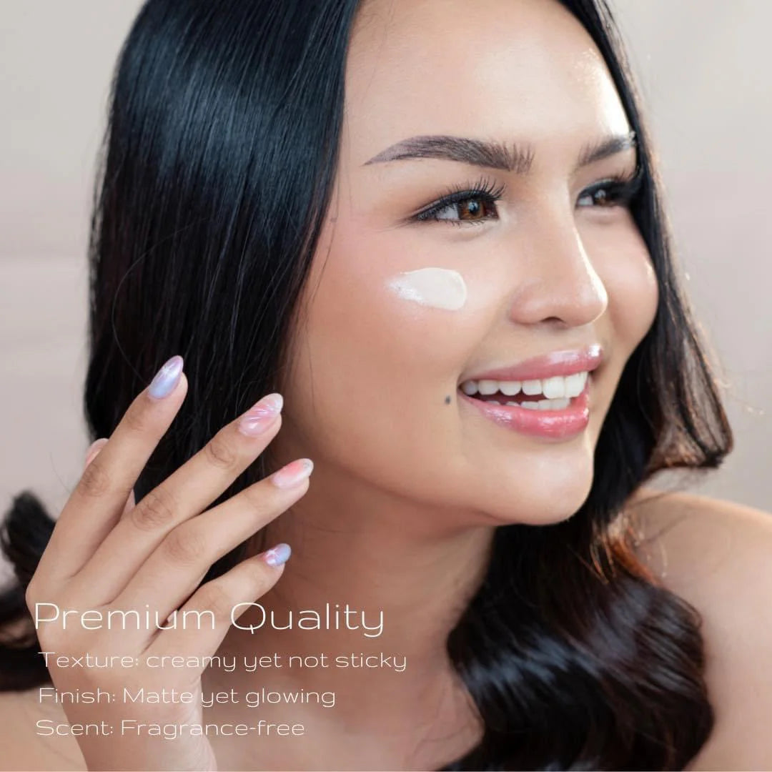 Woman applying cream to her face with a neutral background