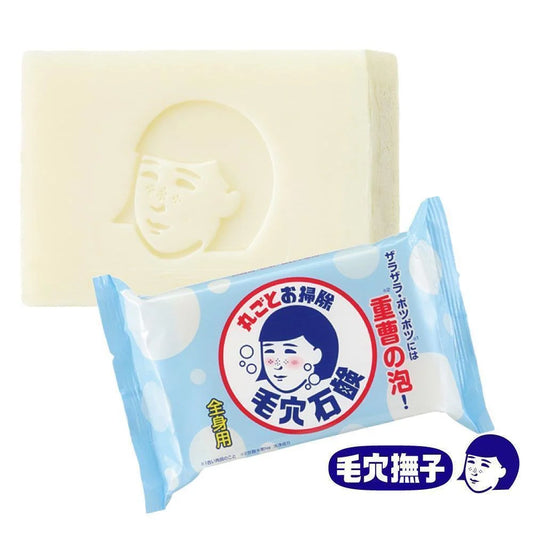 Bar of soap with packaging featuring a face design on a white background