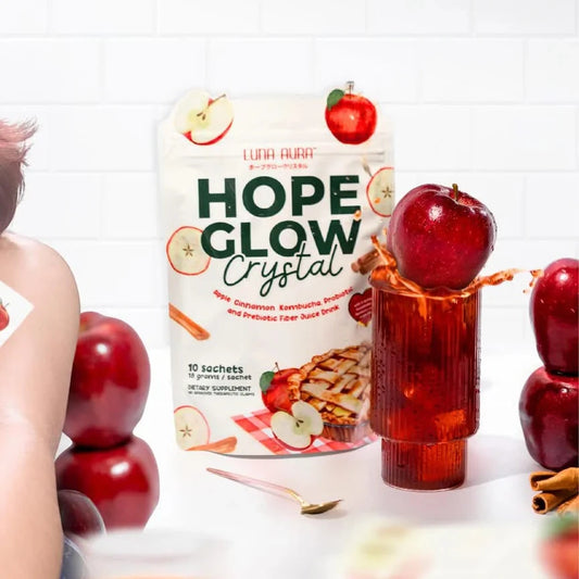Hope Glow Crystal packaging with red apples and a person's arm in the background