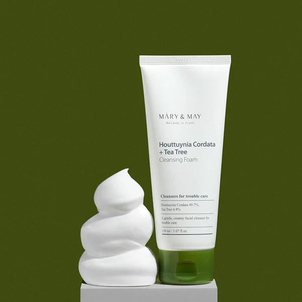 Tube of Mary & May Houttuynia Cordata + Tea Tree Cleansing Foam with foam on a green background