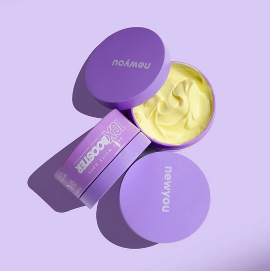 Purple container of cream with 'newyou' branding on a purple background