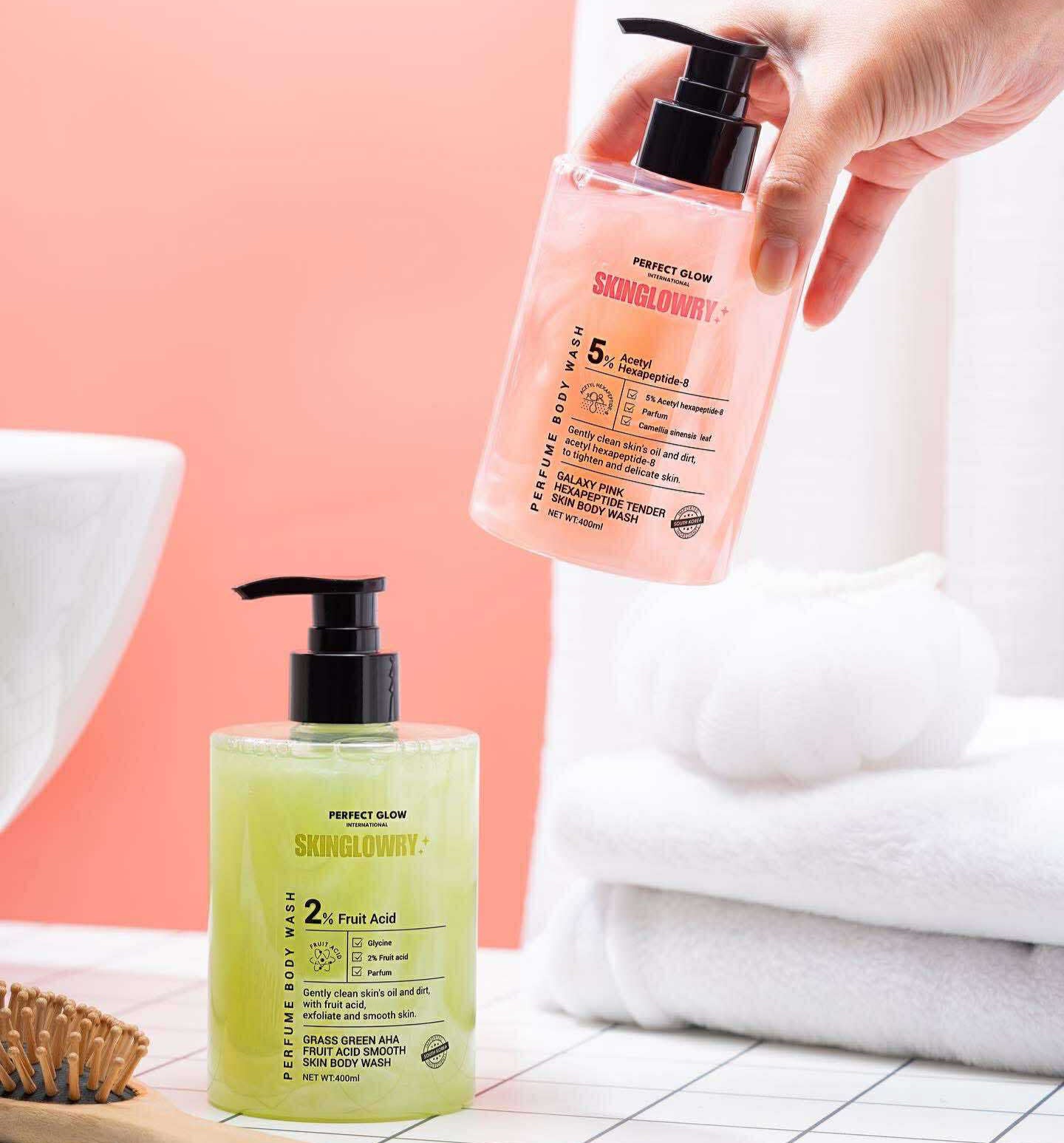 Two skincare products on a bathroom counter with a hand holding one of them.