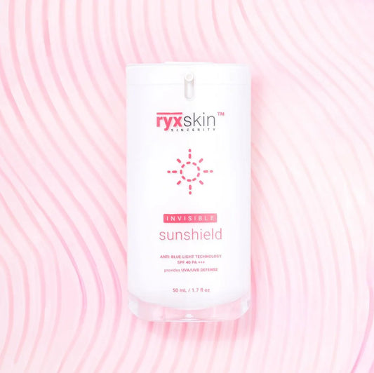 Ryx Skin Sunshield packaging on a pink background