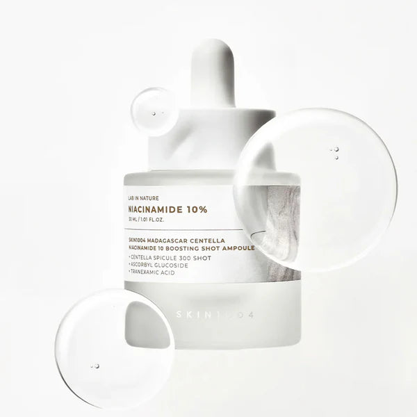 White skincare product with dropper and container on a white background