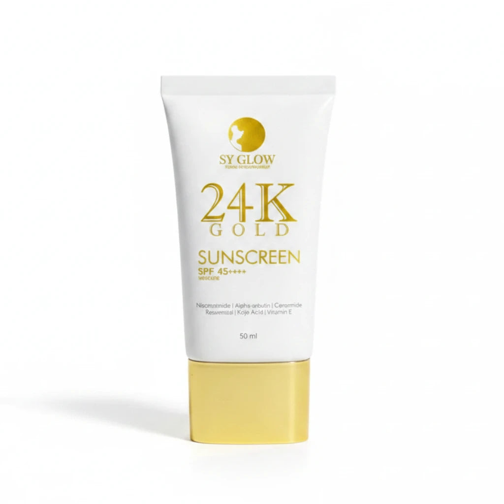 Hand holding a 24K Gold sunscreen tube with a blurred background