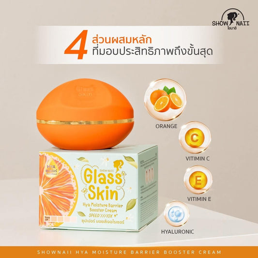 Orange skincare product with packaging and ingredients on a beige background