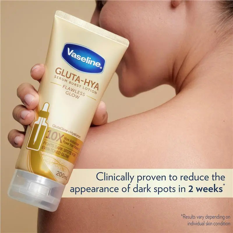 Vaseline Gluta-Hya lotion tube held by a person with text about dark spot reduction.