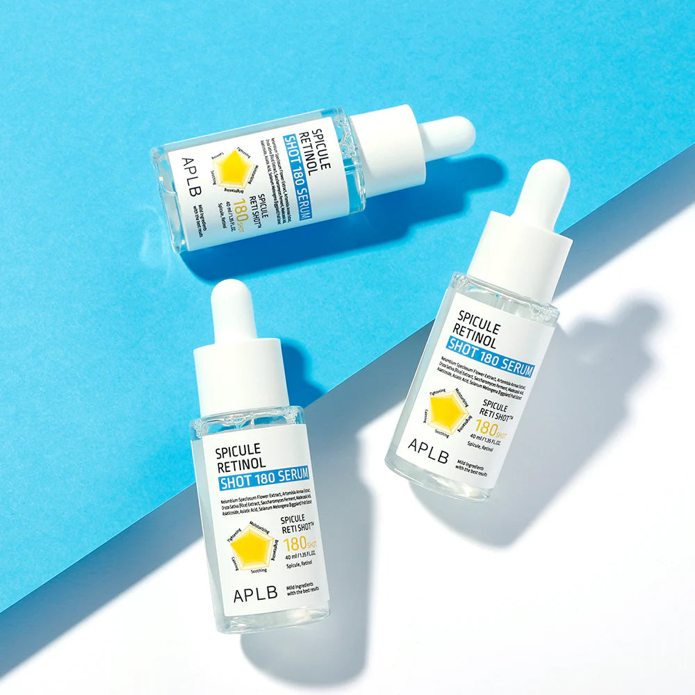Three bottles of APLB Spicule Retinol Shot 100 Serum on a blue background