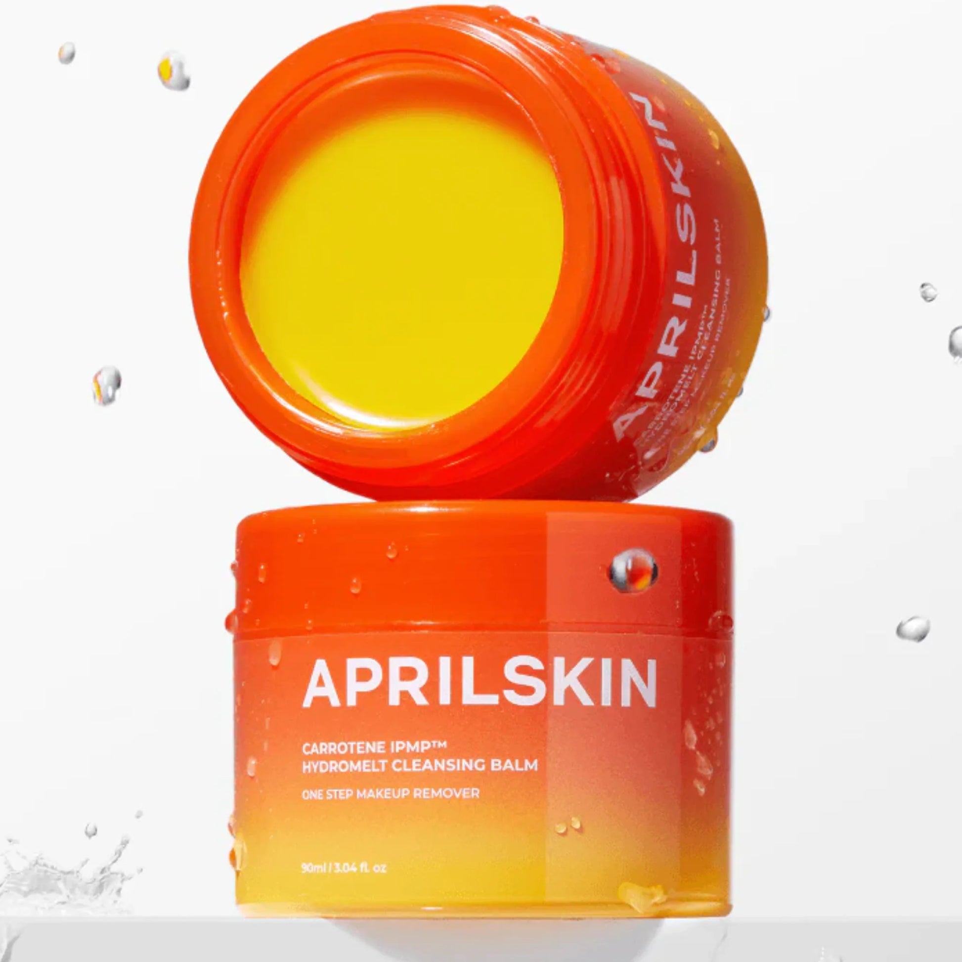 Orange skincare balm jar with 'APRILSKIN' branding on a white background
