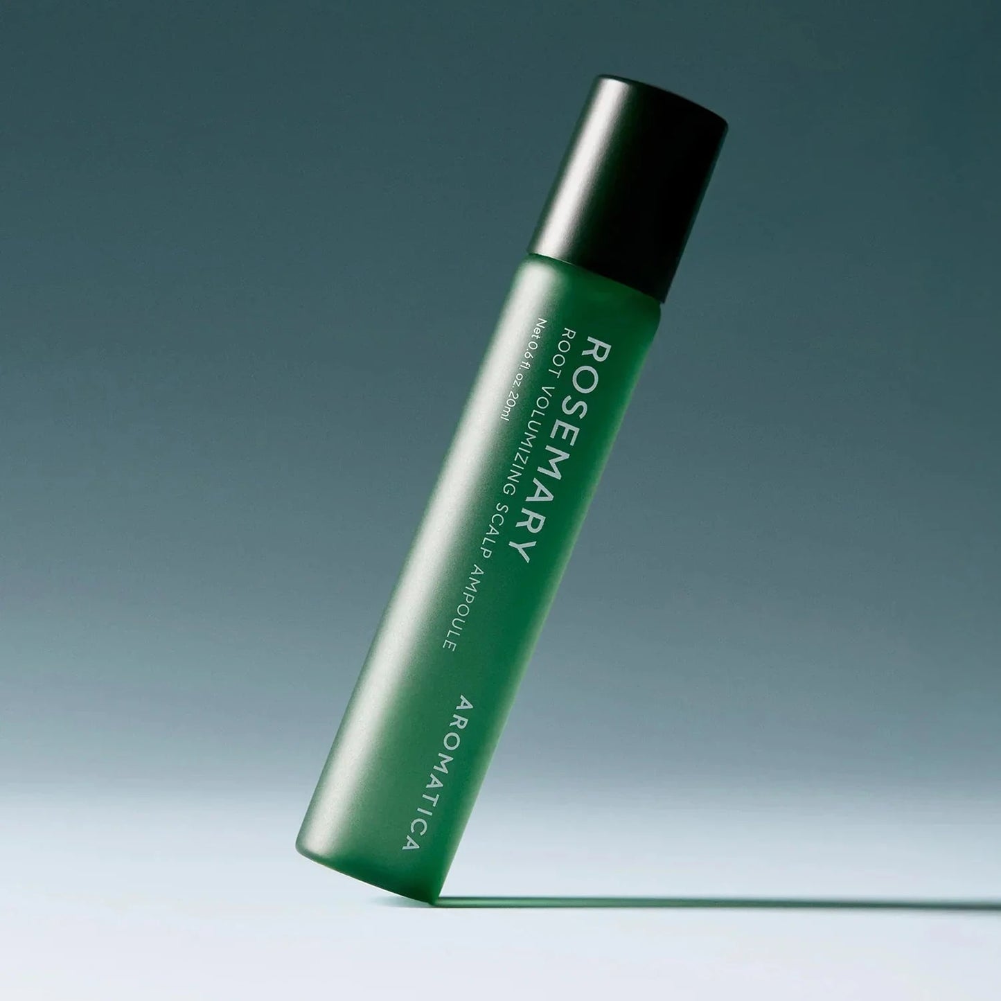 Green roll-on bottle with black cap on a gradient blue background
