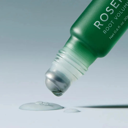 Green bottle of Rosette Root Volumizer with dropper on a light gray background