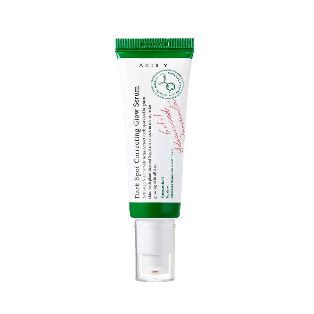A AXIS-Y Dark Spot Correcting Glow Serum in a white tube with a green cap, labeled for brightening and anti-aging benefits.