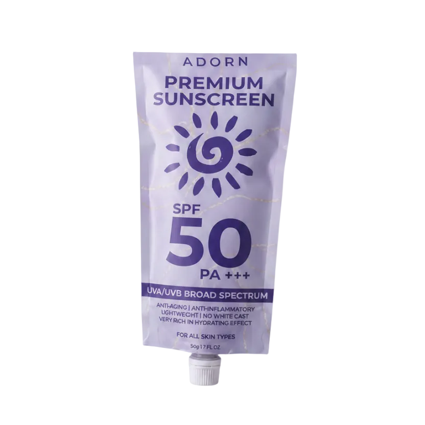 Adorn Premium Sunscreen SPF 50 PA+++ on a light purple background
