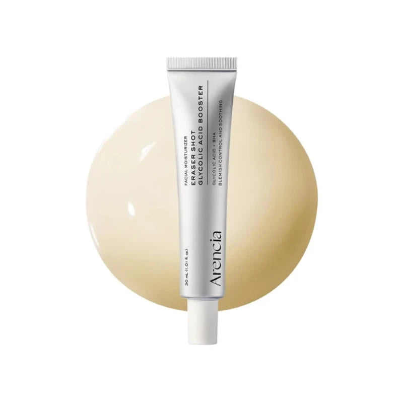 A tube of Avencia Eraser Shot + Booster makeup remover, standing vertically in front of a large, glossy beige circular shape on a solid white background.