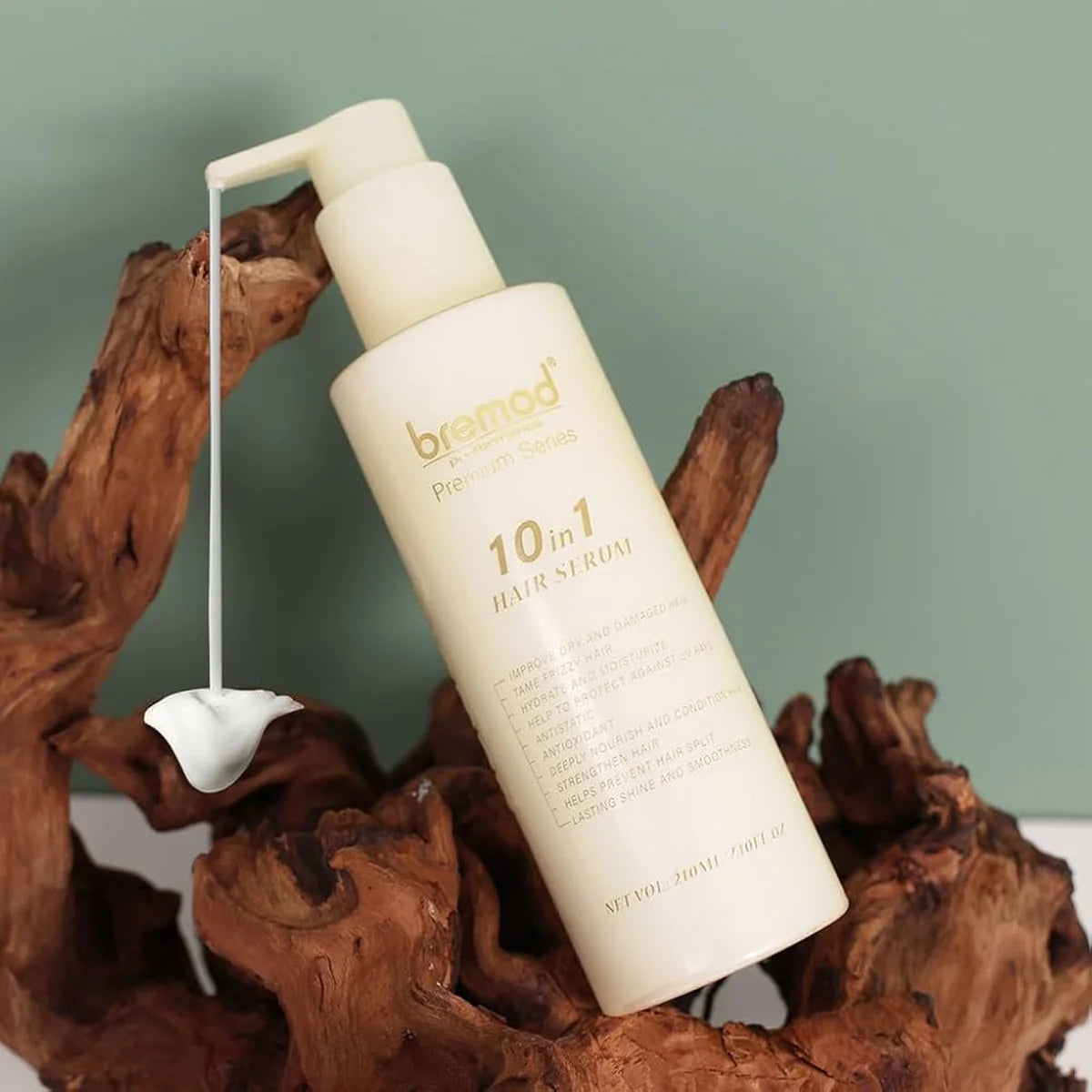 Breatheod 10-in-1 hair serum bottle on a wooden surface with a green background