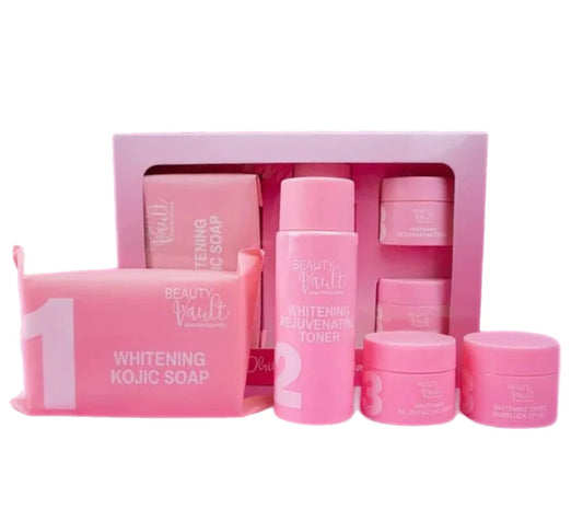 A collection of skin care products from Beauty Vault, including a whitening kojic soap, maintenance toner, night cream, and pearl white sunblock cream, all in pink packaging.
