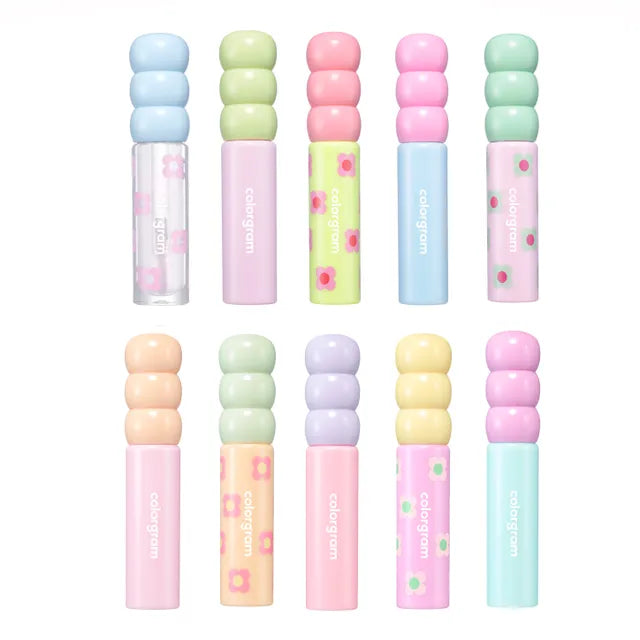 A collection of lip glosses in various colors, each with a glossy, radiant finish.