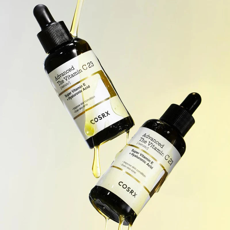 Two bottles of COSRX Advanced The Vitamin C 23 skincare serum on a light yellow background