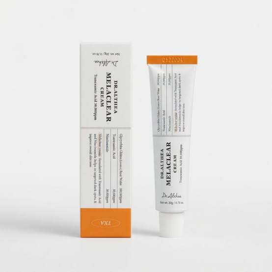 A skincare product set featuring a white tube and matching box of Dr. Altsha's De-Altrea Melclear Cream, with orange accents on the packaging, set against a clean white background.