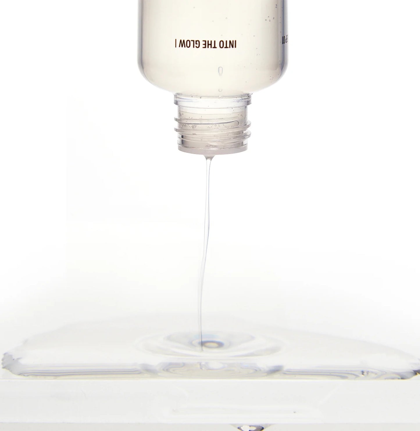 Light bulb with a droplet of liquid dripping from it on a white background