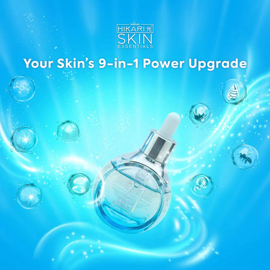 Skincare serum bottle with bubbles on a blue background, featuring Hikari Skin Essentials branding.