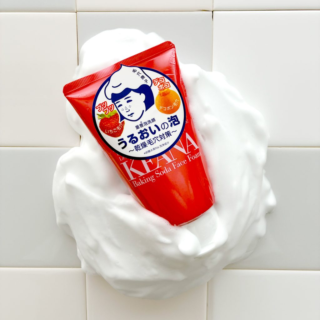 Red Kiana baking soda face foam packaging surrounded by foam on a tiled background