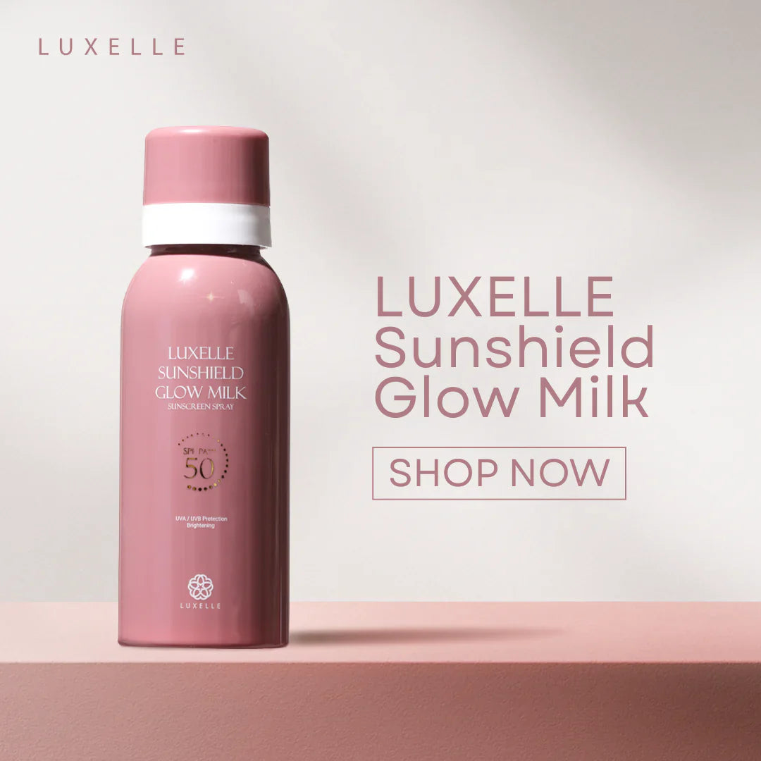 Pink bottle of Luxelle Sunshield Glow Milk on a light pink background with 'Shop Now' text.
