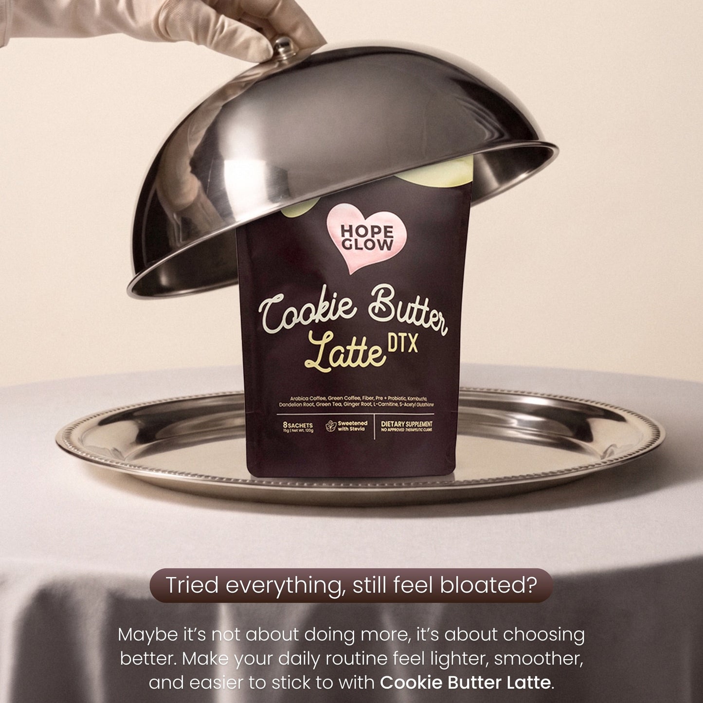 Hope Glow Cookie Butter Latte DTX packaging under a silver serving tray with a gloved hand.