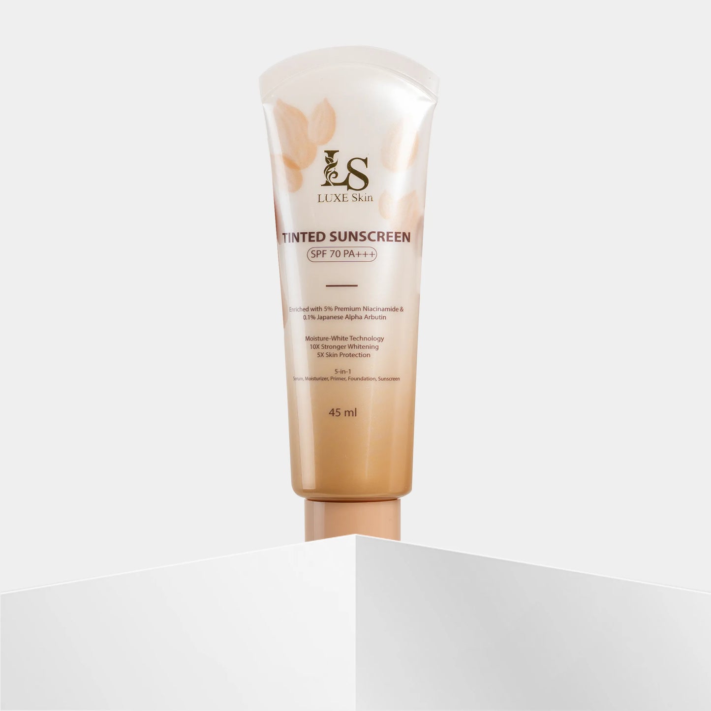 Tube of Luxe Skin tinted sunscreen on a light gray background