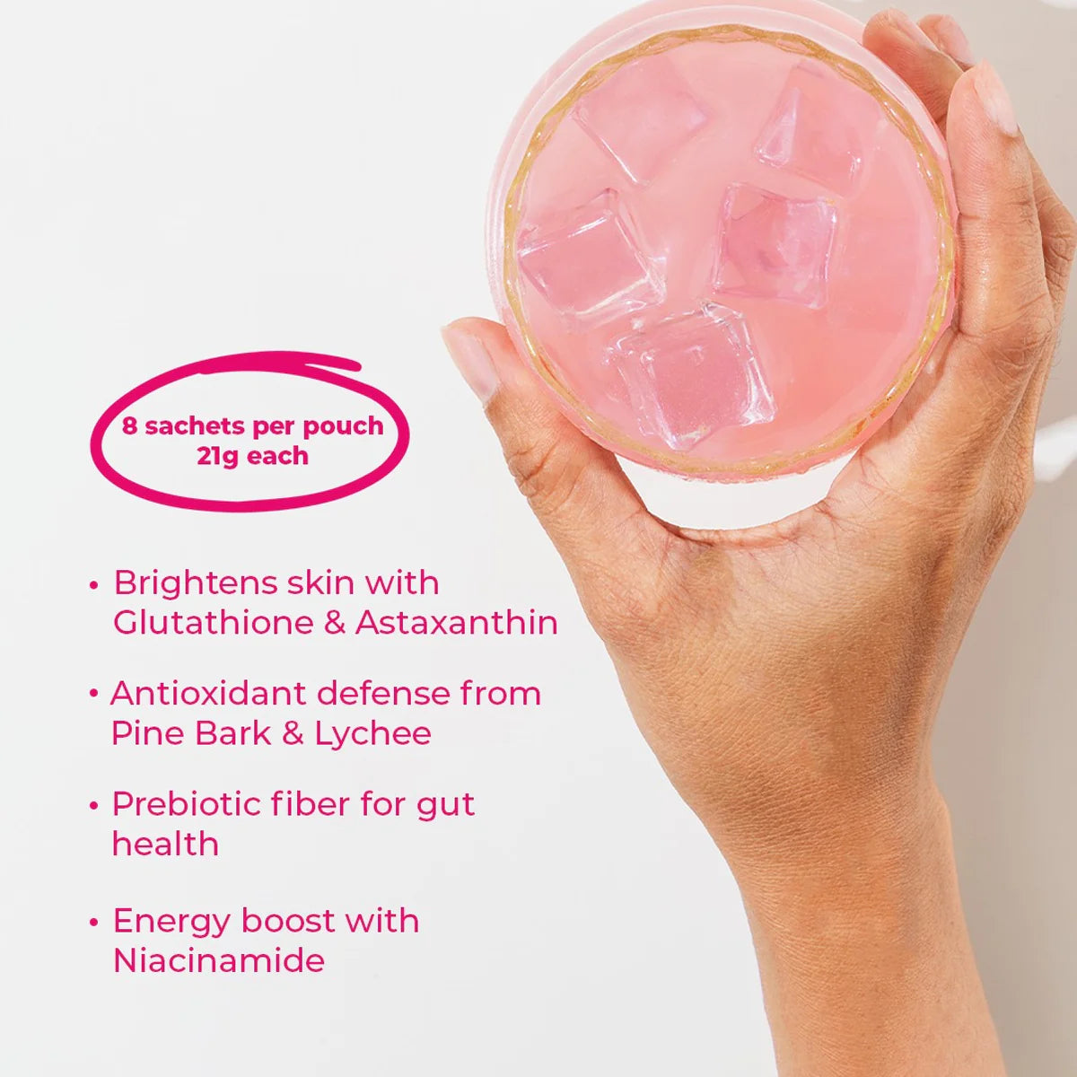 Hand holding a pink container with text about its benefits on a white background