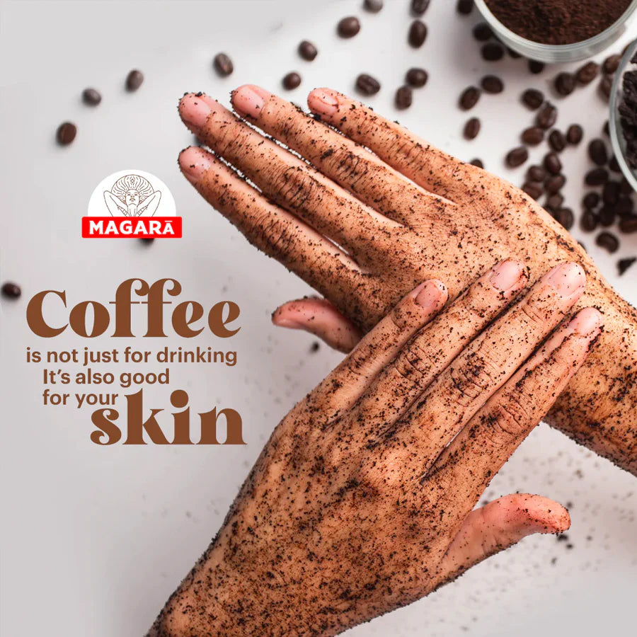 Hands with coffee scrub and scattered coffee beans on a light background, featuring the Magara brand.