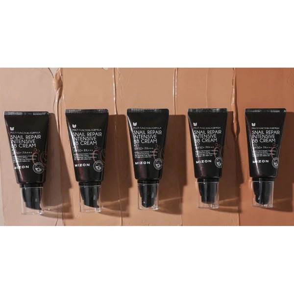 Five black cosmetic tubes with visible branding on a brown background