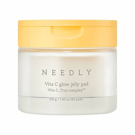 A jar of Needly Vita C Glow Jelly Pad with yellow lid, labeled for brightening and moisturizing the skin.
