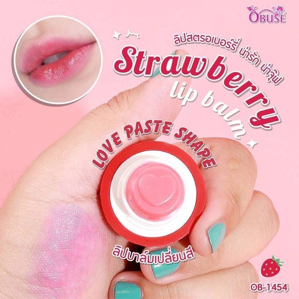 Strawberry lip balm with a hand holding it, labeled 'Love Paste Shape', on a pink background.