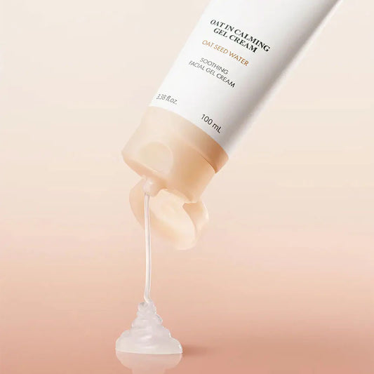 Oat seed water facial gel cream being squeezed out of a tube on a light pink background