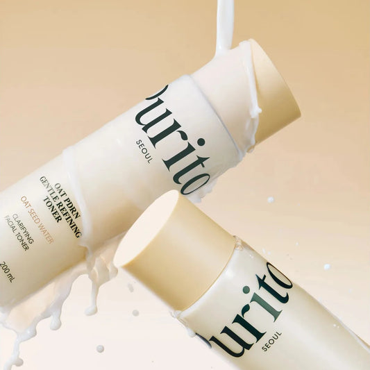 Two bottles of Purito skincare product on a beige background with white liquid.