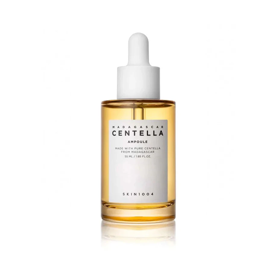 A clear glass bottle with a dropper containing yellow liquid, labeled as 'Madagascar Centella Ampoule'.