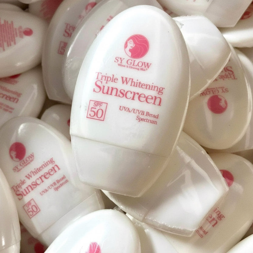 Multiple bottles of SY Glow Triple Whitening Sunscreen on a white background