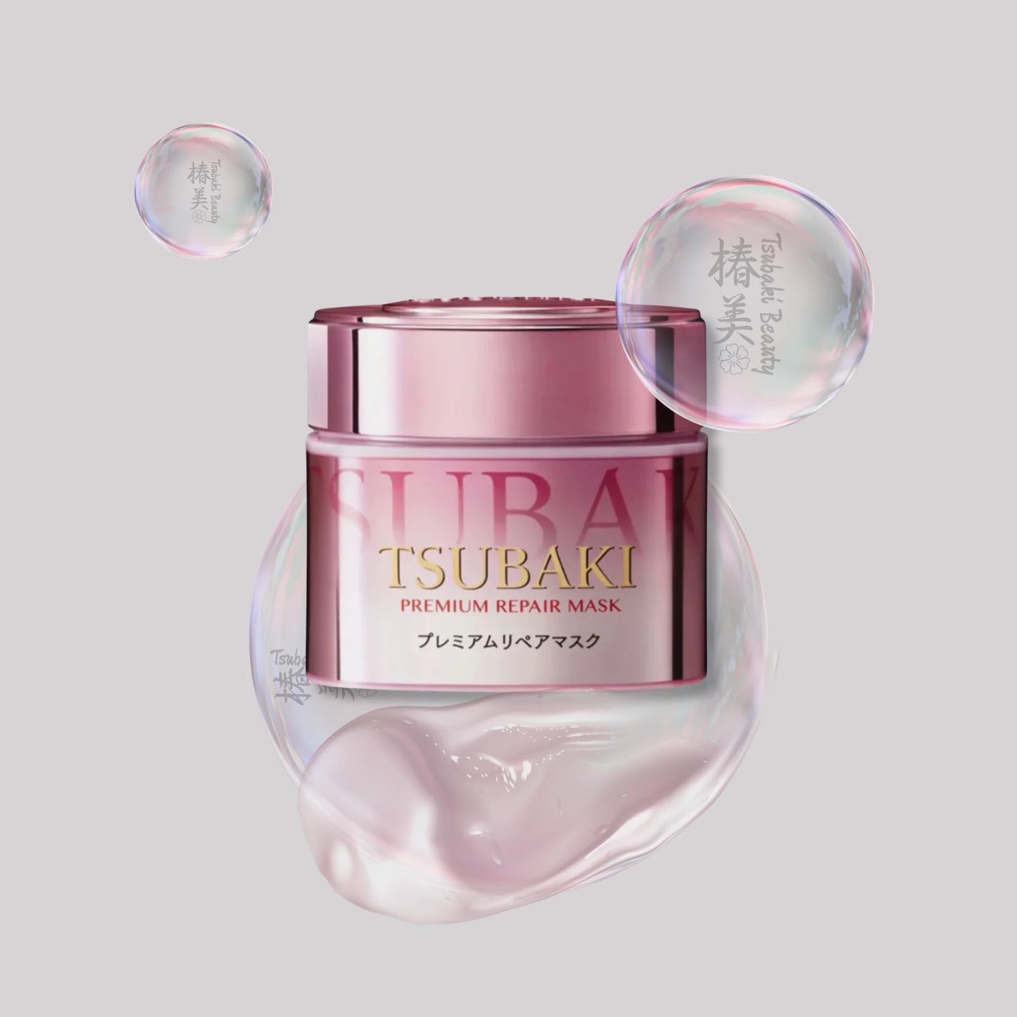 A jar of Tsubaki Premium Repair Mask by Shiseido, featuring a metallic pink container with gold lettering, surrounded by translucent pink cosmetic bubbles on a solid gray background.