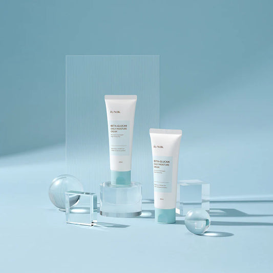 Two skincare products on a light blue background with transparent stands.