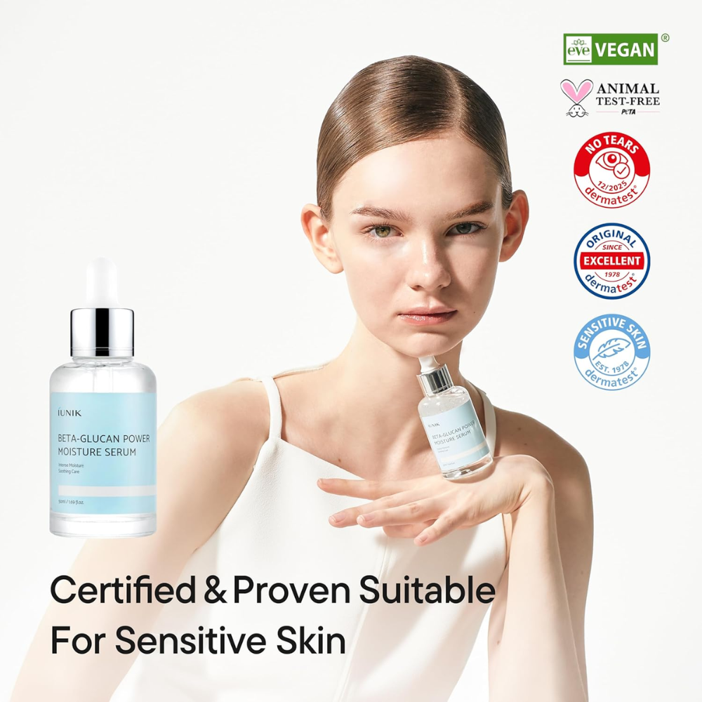 Woman holding a skincare serum bottle with certification logos on a white background