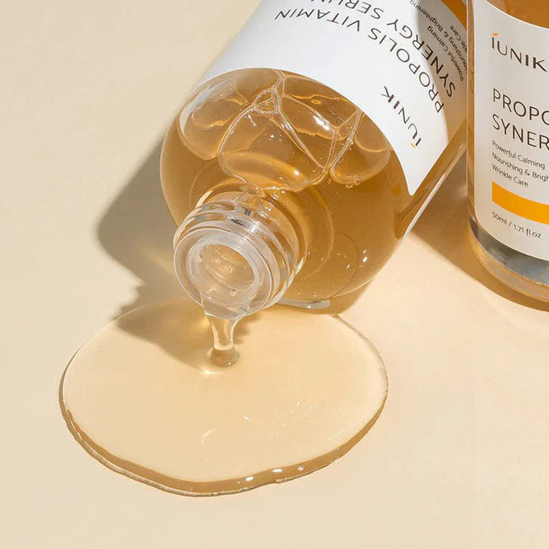 Bottle of skincare serum with dropper on a beige background
